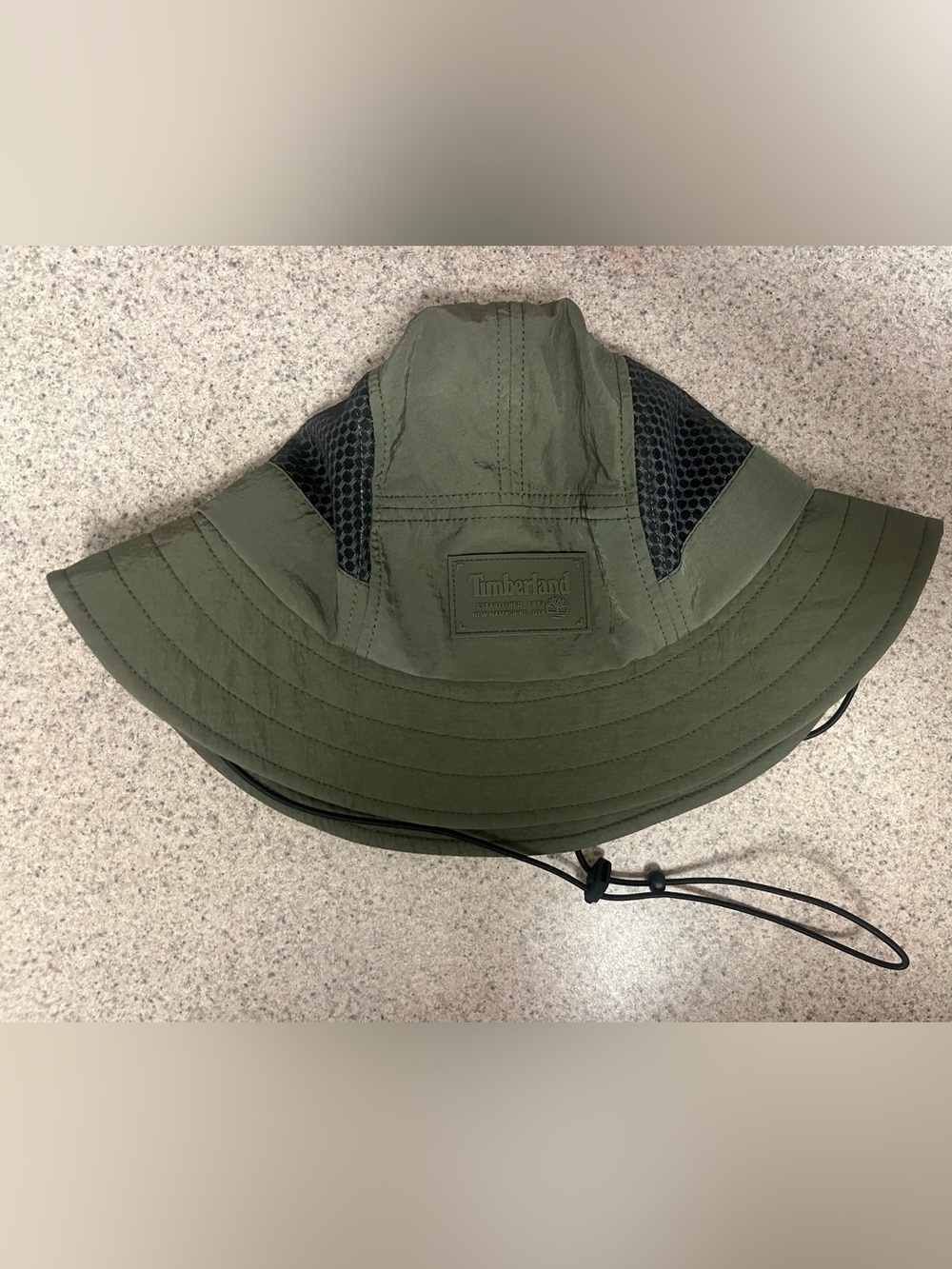 Timberland Olive Green Packable Outleisure Hat with Black Mesh Panels.